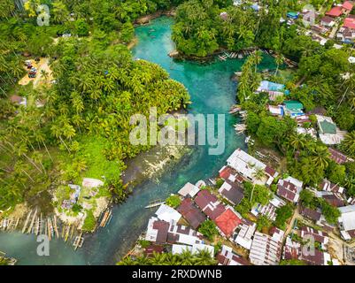 Blue clear water over the Bogac Cold Spring surrounded by villlages and ...