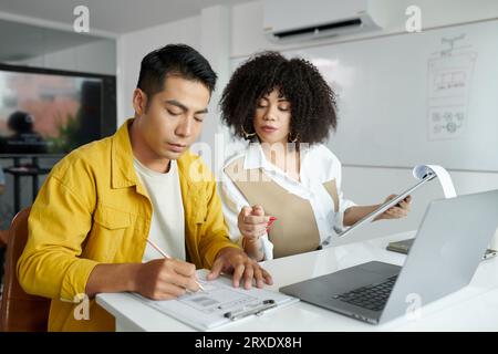 UI and UX designers working on new website interface wireframe Stock Photo