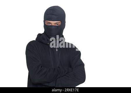 Mysterious man wearing black hoodie standing and looking at camera. Isolated image on gray background Stock Photo