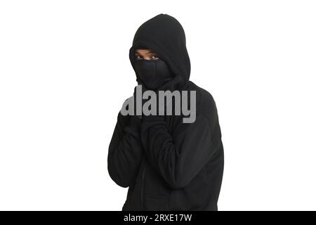Mysterious man wearing black hoodie standing and looking at camera. Isolated image on gray background Stock Photo