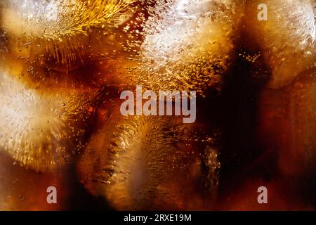 Cola and ice cubes macro texture. Cola drink with ice closeup background. Stock Photo