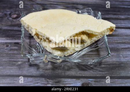 Traditional tahini halva, plain halawa tahiniya in a cornbread, a quick bread made with cornmeal, the cuisine of the Southern United States, with orig Stock Photo