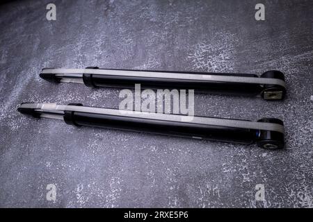 Car shock absorbers on gray. Auto parts. Stock Photo