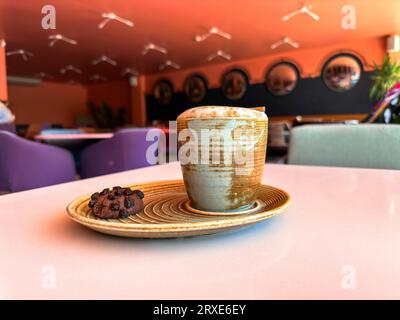 Cup of coffee and cookie in a nice modern cafe Stock Photo