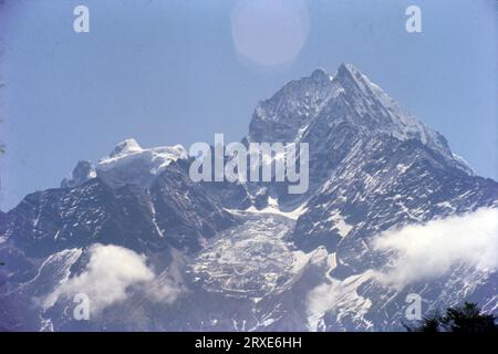 Thamserku is a mountain in the Himalayas of eastern Nepal. The mountain is connected by a ridge leading eastward to Kangtega. Thamserku is a prominent mountain to the east of Namche Bazaar and lies just north of Kusum Kangguru. Stock Photo