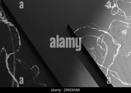 Simple black and white marble background with light streaming in. Stock Photo