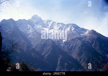 Thamserku is a mountain in the Himalayas of eastern Nepal. The mountain is connected by a ridge leading eastward to Kangtega. Thamserku is a prominent mountain to the east of Namche Bazaar and lies just north of Kusum Kangguru. Stock Photo