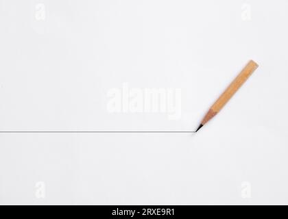 Pencil draws a horizontal line on white background. Stability and continuity in business. Stock Photo