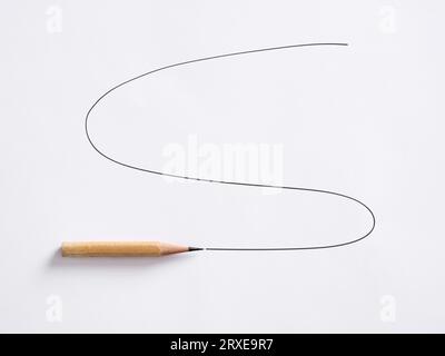 Flexibility concept. Graphite pencil drawing a scribble line on white paper. Stock Photo
