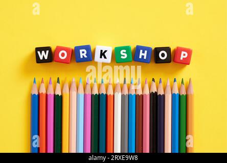 The word workshop on colorful cubes with crayons. Stock Photo