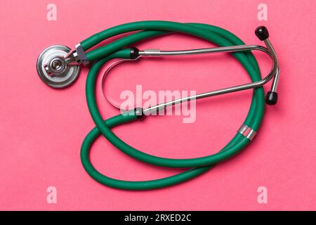 Top view of green stethoscope on colorful background. Medical diagnosis tool concept. Stock Photo