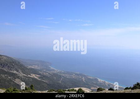 View on Dhermi from the famous SH8 road at the Llogara Pass in Albania - a high mountain pass within the Ceraunian Mountains along the Albanian Rivier Stock Photo