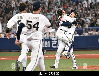 Orix Buffaloes Soichiro Yamazaki R hugs teammate Tomoya Mori as