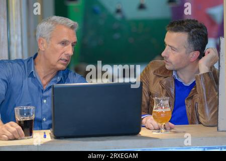 businessmen working with a laptop in an pub Stock Photo