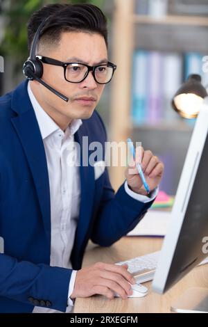 serious asian businessman using a computer Stock Photo