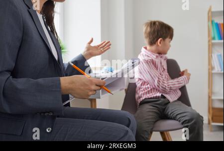 Problem child doesn't want to talk during meeting with therapist or psychologist Stock Photo