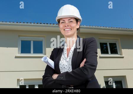 employee woman in helmet with paper documents Stock Photo