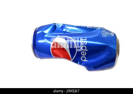 Cairo, Egypt, September 19 2023: Crushed dented Pepsi can, Cola flavor bottle, a carbonated soft drink manufactured by PepsiCo. Originally created, de Stock Photo
