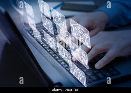 Close-up of a man's hands on a laptop keyboard and virtual screen with business, banking and finacical icons. Concept of business and finance industry Stock Photo