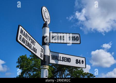 Signs to Maryport, Ravenglass, Wallsend and Rome at Bowness on Solway, Cumbria Stock Photo