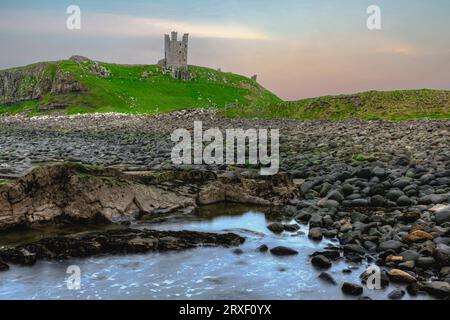 The ruins of Dunstanburgh Castle at the North Sea coastline in Northumberland, England Stock Photo