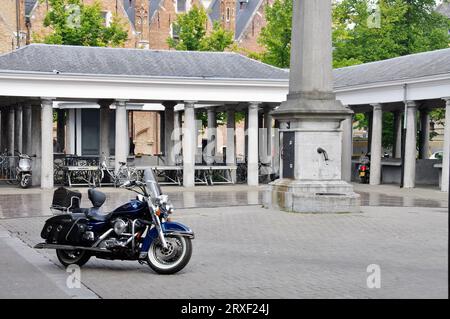 Blue Harley Davidson Motorcycle parked in the  historical Bruges fish market. Bruges, Belgium Stock Photo