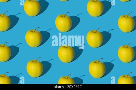 Trendy fruit pattern made of yellow apples on light pastel blue background. Minimal layout. Nature summer concept. Stock Photo