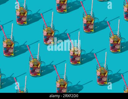 Trendy summer cocktail pattern made of colorful gummy candies on light blue background. Minimal creative idea. Nature beach concept. Stock Photo