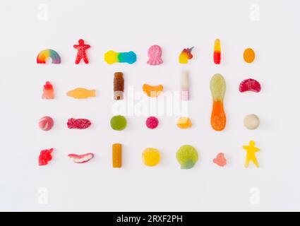 Creative pattern made of colorful gummy candies on white background. Minimal trendy concept. Flat lay, top of view. Stock Photo