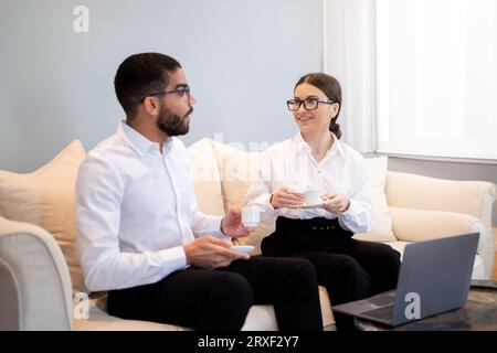 Diverse Business Colleagues Having a Meeting on the Office Sofa Stock Photo