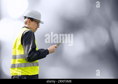 Engineer with digital tablet. on a gray background. Stock Photo