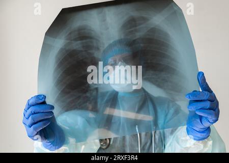 Woman doctor looking at x-ray of lungs. Stock Photo