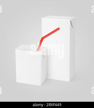 Group of different milk or juice carton packages with red straw on gray background with clipping path Stock Photo