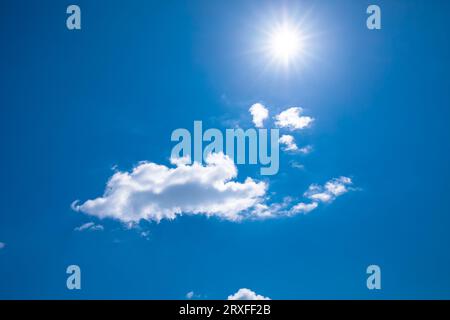 Cloud and the sun on clear blue sky, bright day view Stock Photo