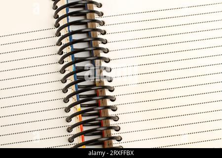 A spiral dotted line notebook in a close up view Stock Photo