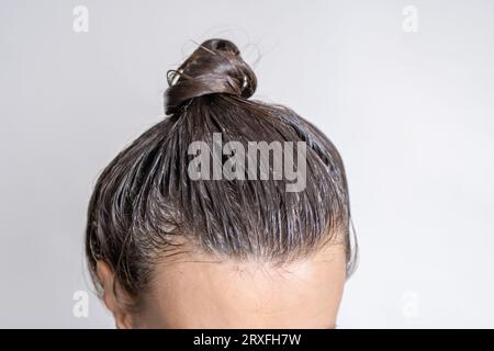 Close-up of a woman's head in the process of hair coloring  Stock Photo