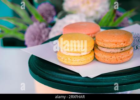 Three macarons. Tasty cakes of different color.  Concept very tasty dessert. Multicolored Macaroons. close-up Stock Photo