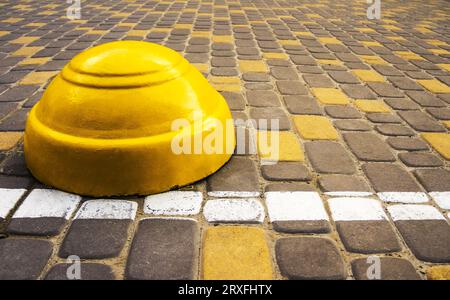 Striped concrete barrier in a parking lot Stock Photo - Alamy