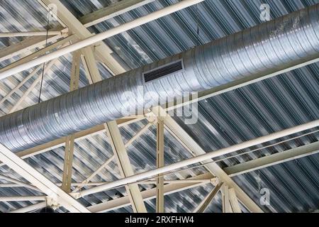 Metal designs of a roof and pipe of ventilation. metal roof structures with a vent pipe and spotlights. aluminum profile details Stock Photo