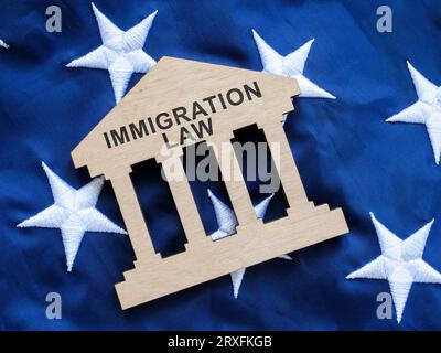 There is sign on the US flag that says Immigration Law. Stock Photo