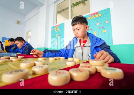 Luannan, China - March 9, 2023: The students are learning Chinese chess in the classroom, North China Stock Photo