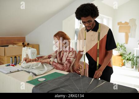 Team of tailors working on order for client in their atelier Stock Photo