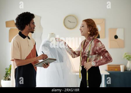 Diverse team of fashion designers discussing new project they are working on Stock Photo