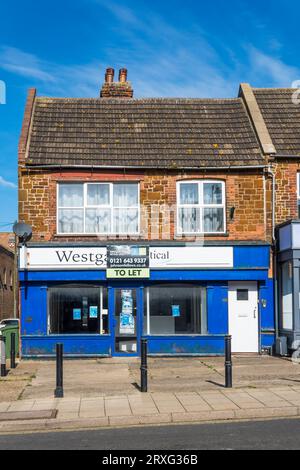 Empty ground floor shop to let beneath a first floor residential flat. Stock Photo