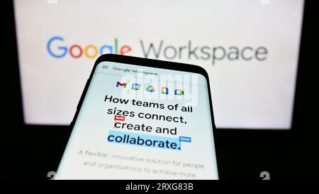Mobile phone with website of business app software Google Workspace on screen in front of business logo. Focus on top-left of phone display. Stock Photo