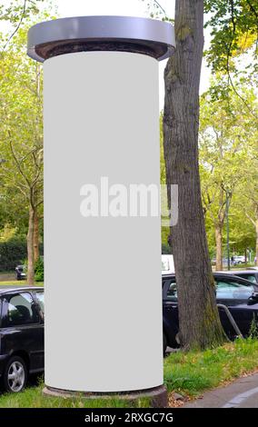 Empty advertising pillar in a city with white  free copy space, promotion mock up. Blank advertising panel Stock Photo