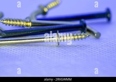 A colorful mix of nails and screws with eyelets and hoes Stock Photo