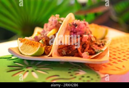 Set of Mexican hats of cheerful colors placed in typical stand for festival days Stock Photo