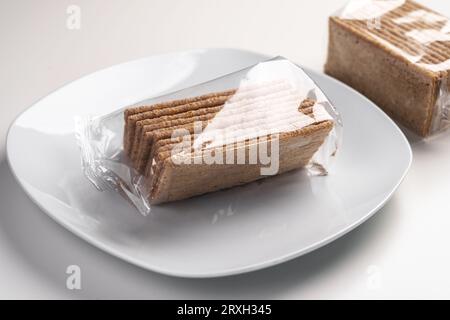 Packed healthy gluten free crackers from buckwheat close up on a white plate Stock Photo