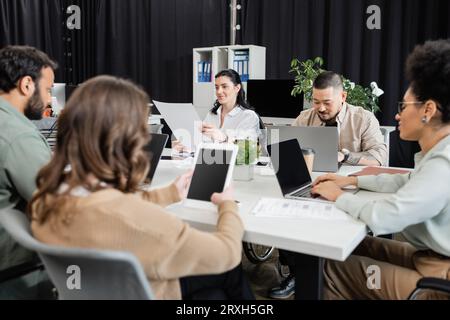 busy hours in modern coworking, interracial team working on startup project and using devices Stock Photo